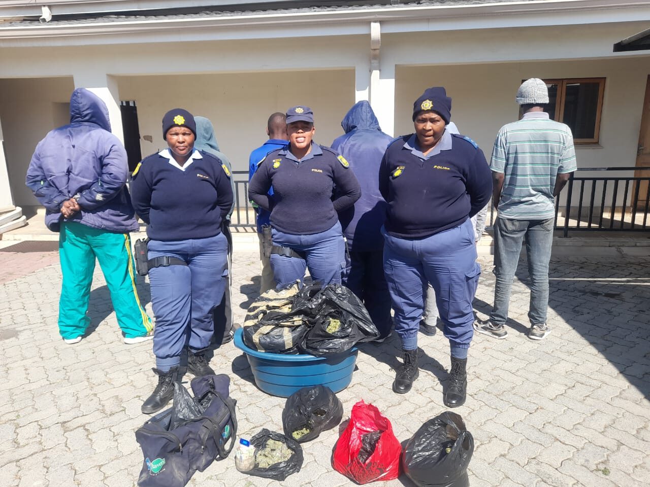 SAPS officers with the suspects arrested for the possession of dagga
