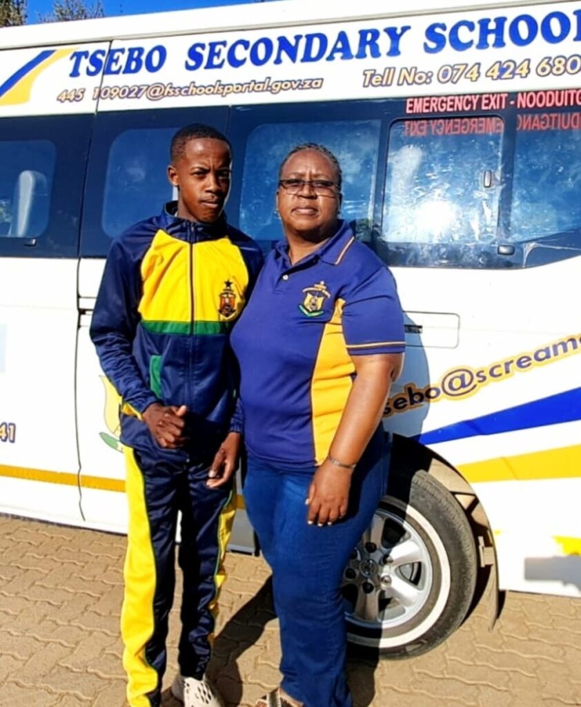 Tsebo SS athlete Khatliso Nkomo standing next to his coach Mannoi Tsotetsi.
