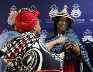 Professor Nwando Achebe being welcomed with a sotho hat and blanket and given the name Masechaba