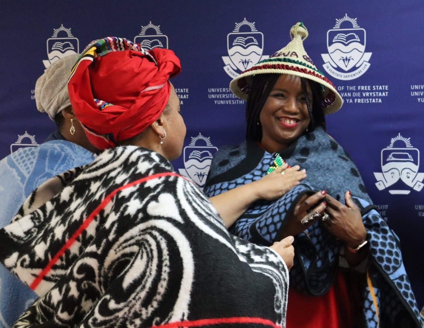 Professor Nwando Achebe being welcomed with a sotho hat and blanket and given the name Masechaba