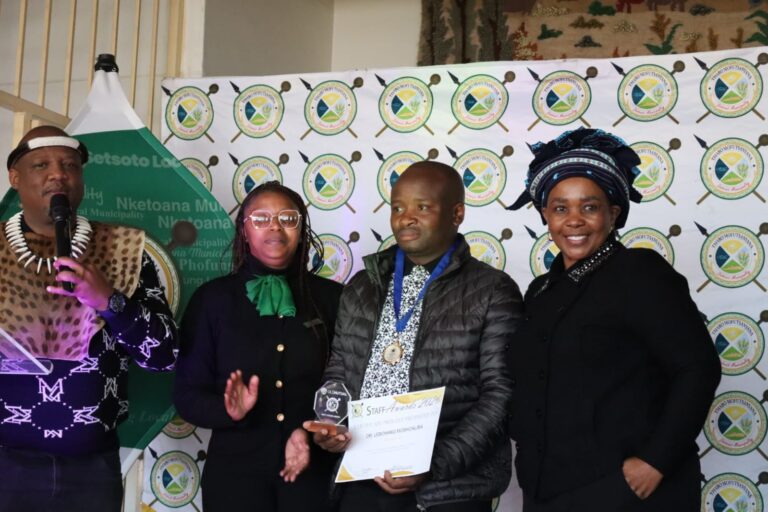 Standout award winner Dr. Lebohang Moshoaliba with the MM Takatso Lebenya on his left as he received one of his awards