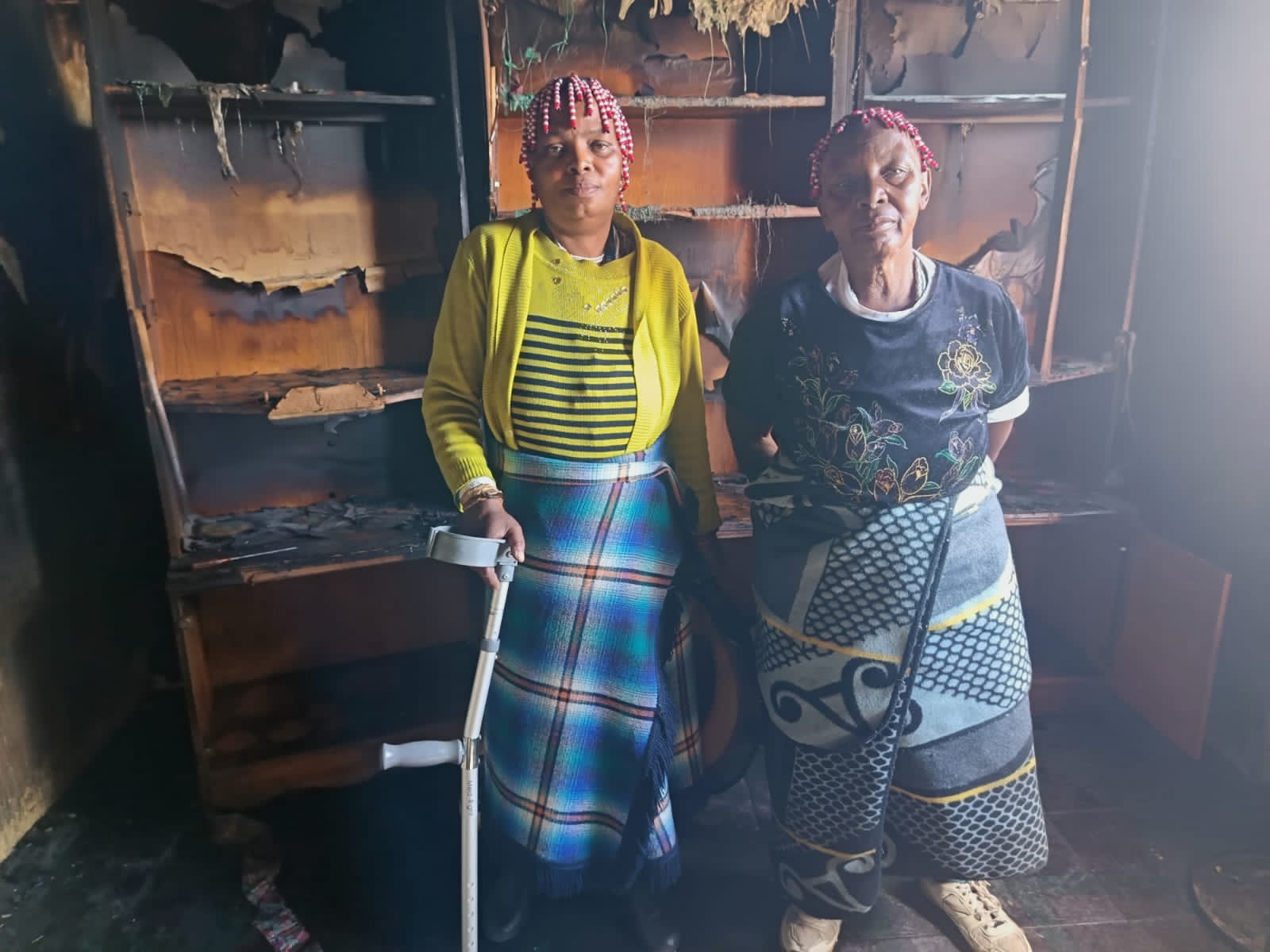 From the left: Paulina Phalo (48) and her mother Annacleda Nhlapo (76) in the burnt house