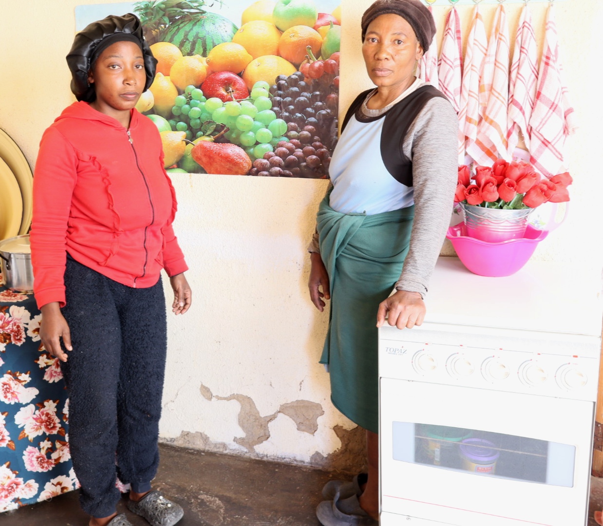 From left: Eunice Mosia (25) and her mother, Maria Mmoneng (56), inside their home, which they say has been affected by flooding and dust from the unfinished road.