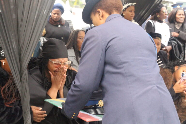 Official handover of the national flag,police and Sgt Kareli police hat to his wife PHOTO SAPS