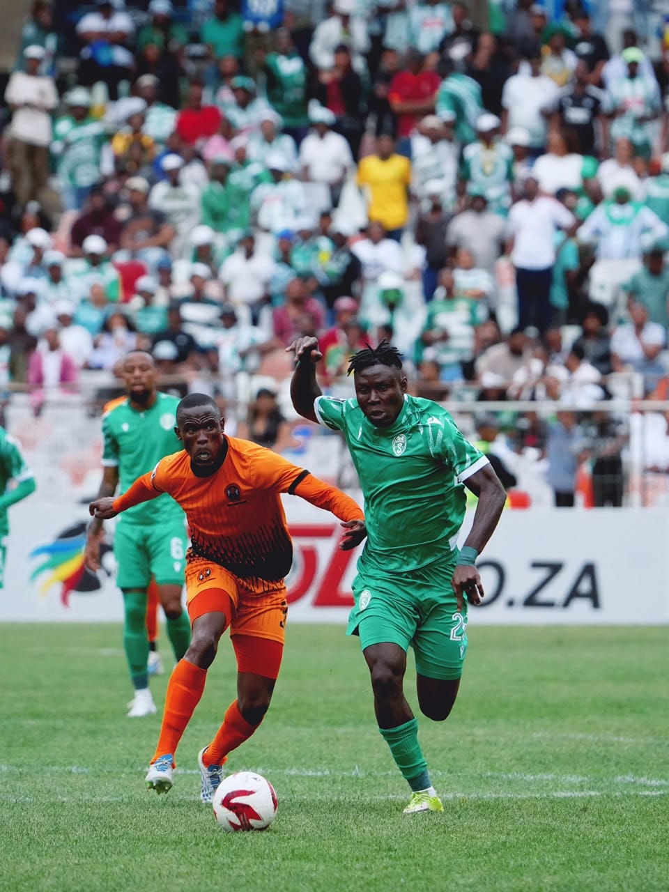 In Photo (supplied by Siwelele FC): Michel N'Guessan of Siwelele FC (green) going for the ball against Polokwane City FC (orange) in a BetWay Premiership clash.